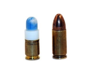 A Simunition marking cartridge as compared to an actual 9mm cartridge.