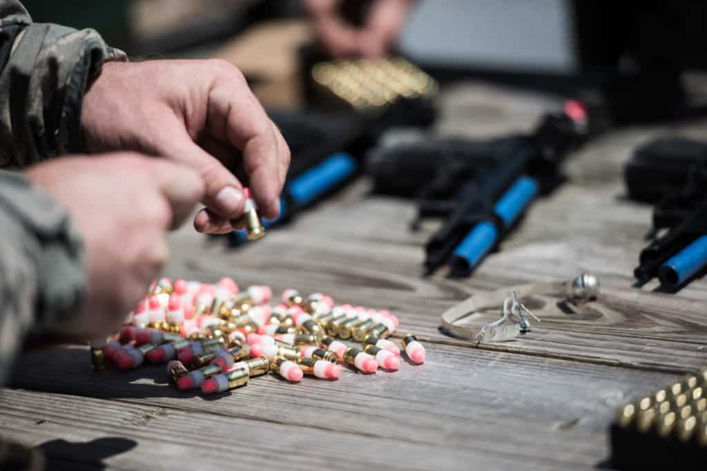 Loading Simunition marking cartridges into the magazine for a converted weapon.  Also visible is the converted weapon.