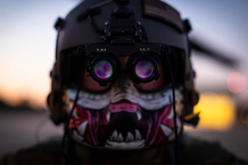 A helicopter crew chief wearing night vision goggles.